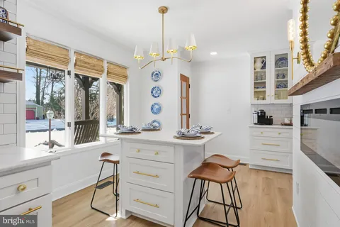 a kitchen with a table chairs refrigerator and cabinets