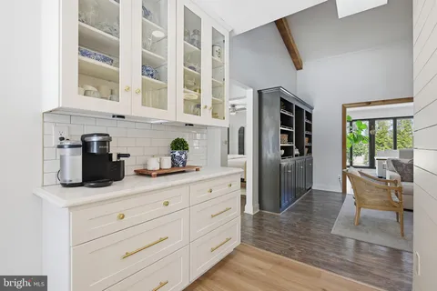a kitchen with stainless steel appliances kitchen island granite countertop a refrigerator and cabinets
