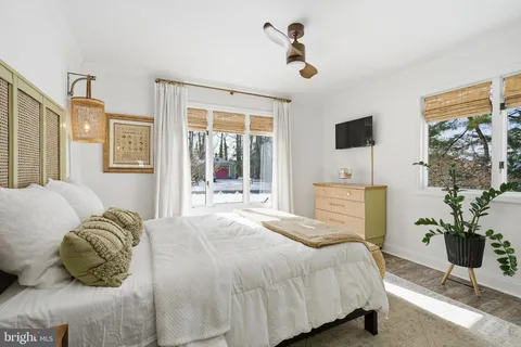 a bedroom with a bed and a potted plant