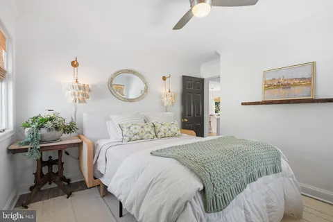 a bedroom with a bed and chandelier