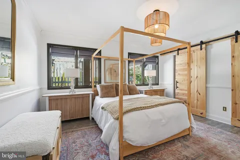 a bedroom with a bed next to a window with outer view