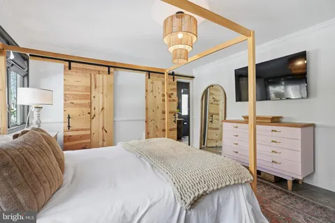 a bedroom with a bed and a flat screen tv