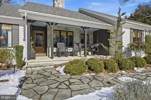 a view of a house with potted plants