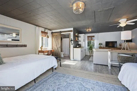 a bedroom with a bed chair and window