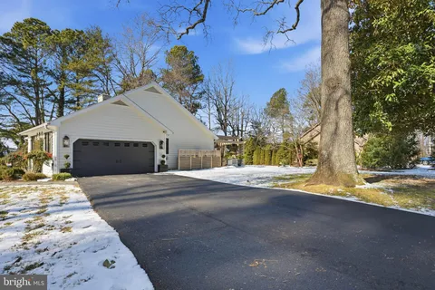 an aerial view of a house with garden space and sitting area