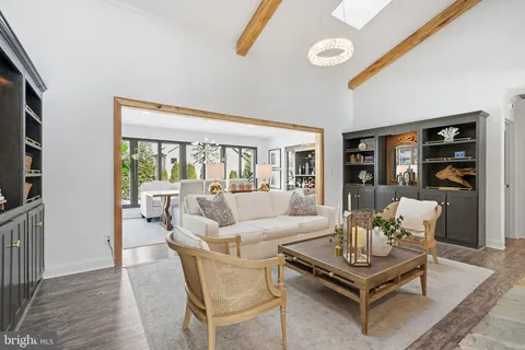 a living room with furniture a rug and a flat screen tv
