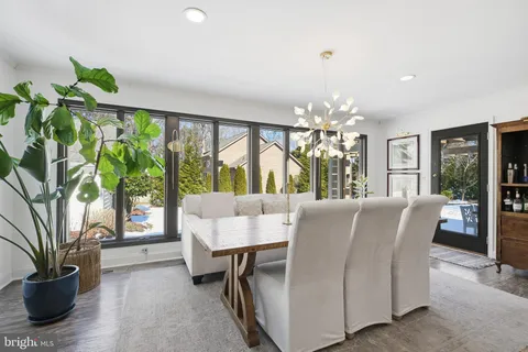 a dining room with furniture a potted plant and a chandelier