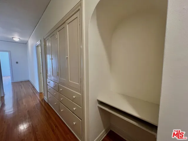 a view of hallway with wooden floor