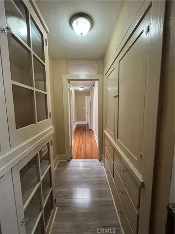 a view of hallway with stairs and wooden floor