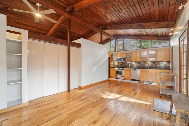 a view of a room with wooden floor