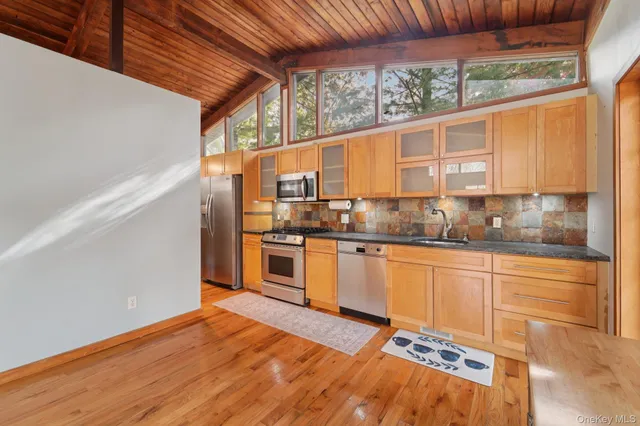 a kitchen with stainless steel appliances granite countertop a stove and a sink