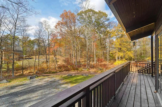 a view of balcony with wooden floor and fence
