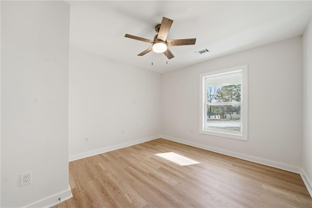 1136 Powell Court Southeast Atlanta, GA 30316 - Photo 13 of 33 an empty room with wooden floor ceiling fan and windows