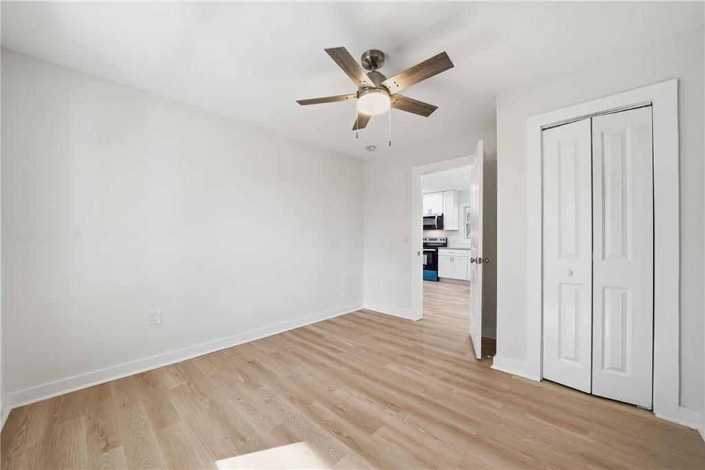 1136 Powell Court Southeast Atlanta, GA 30316 - Photo 15 of 33 an empty room with wooden floor and windows