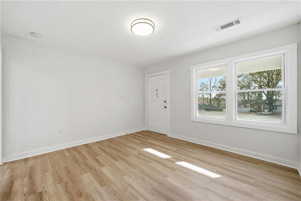 1136 Powell Court Southeast Atlanta, GA 30316 - Photo 16 of 33 an empty room with wooden floor and windows