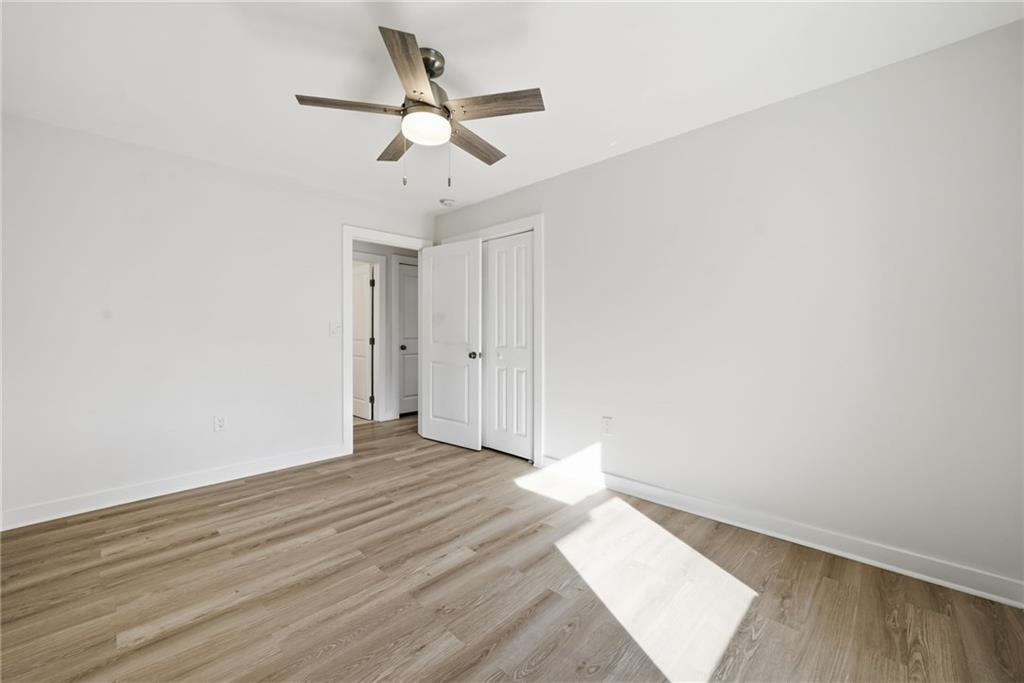 1136 Powell Court Southeast Atlanta, GA 30316 - Photo 18 of 33 an empty room with wooden floor and ceiling fan
