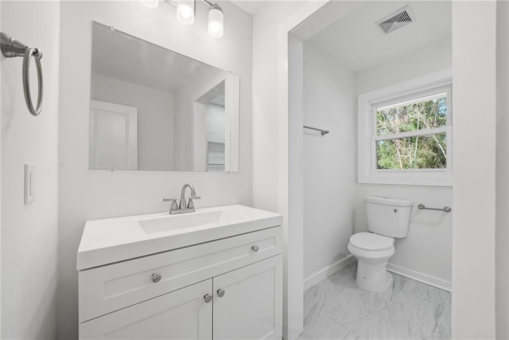 1136 Powell Court Southeast Atlanta, GA 30316 - Photo 20 of 33 a bathroom with a sink a toilet and a mirror