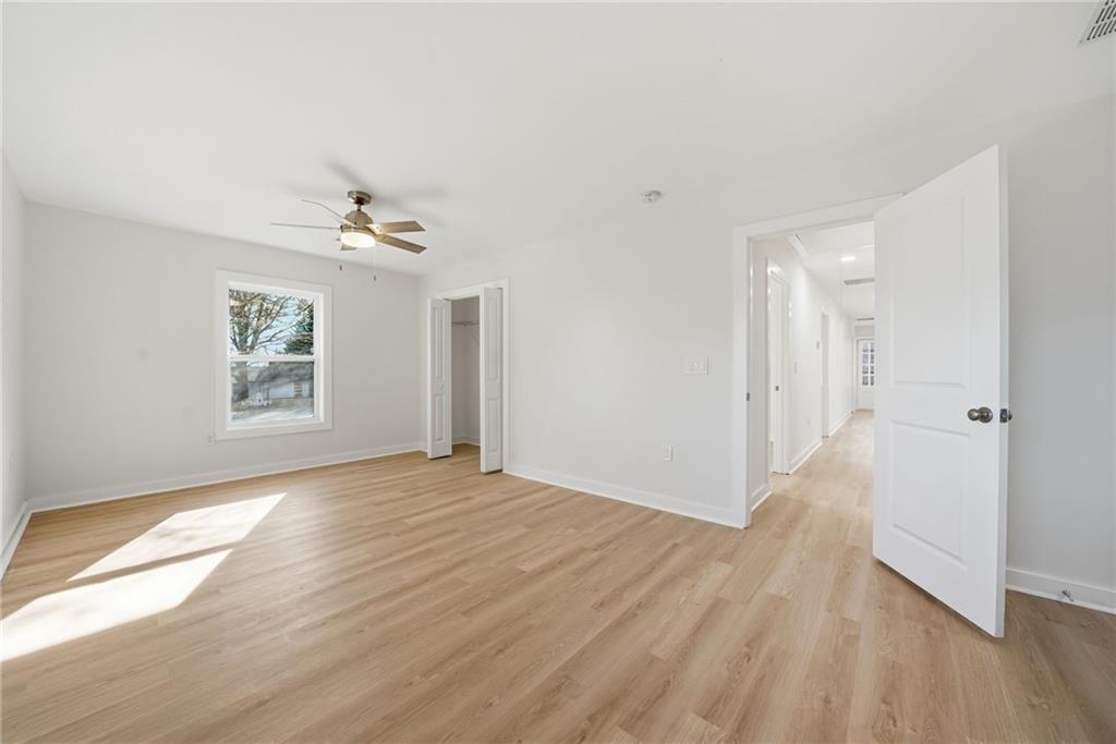 1136 Powell Court Southeast Atlanta, GA 30316 - Photo 22 of 33 a view of an empty room with wooden floor and a window