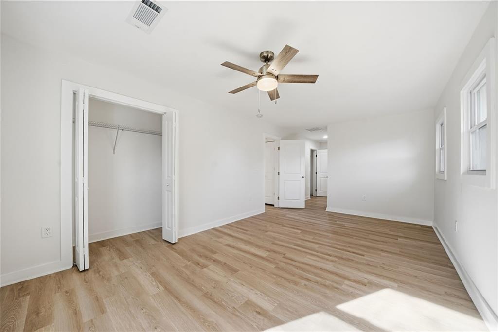 1136 Powell Court Southeast Atlanta, GA 30316 - Photo 23 of 33 a view of empty room with wooden floor and ceiling fan