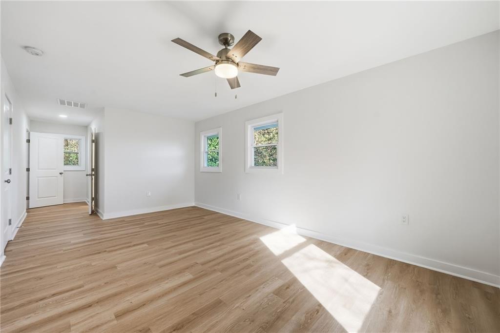 1136 Powell Court Southeast Atlanta, GA 30316 - Photo 24 of 33 wooden floor in an empty room with a window