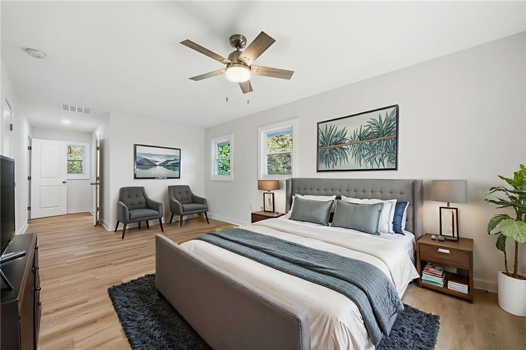 1136 Powell Court Southeast Atlanta, GA 30316 - Photo 25 of 33 a bedroom with a bed and wooden floor