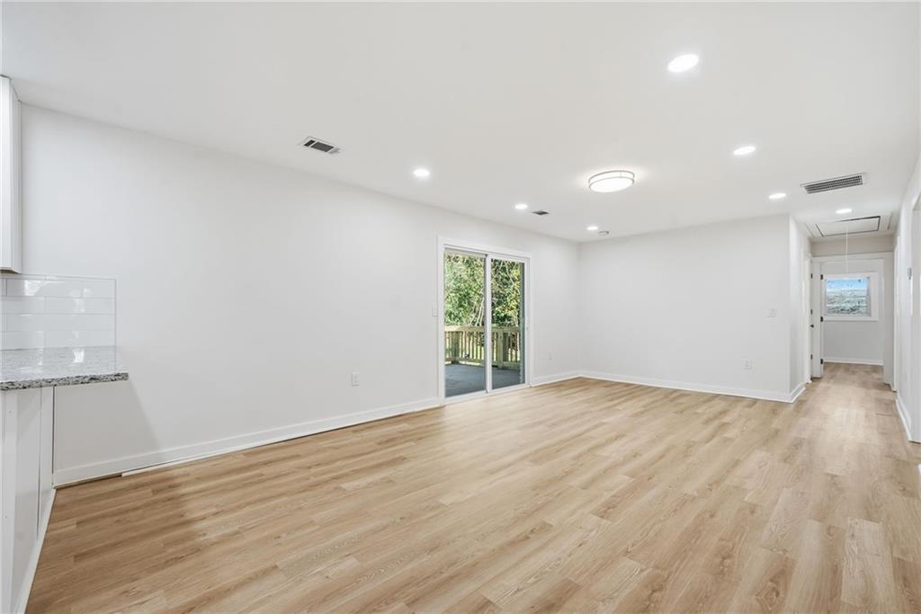 1136 Powell Court Southeast Atlanta, GA 30316 - Photo 3 of 33 a view of an empty room with wooden floor and a window