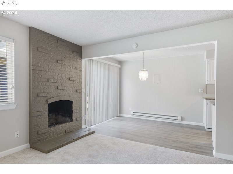 2921 Northeast Rene Avenue, Unit 15B Gresham, OR 97030 - Photo 18 of 22 a view of empty room with wooden floor and fireplace