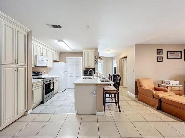a kitchen with a sink and chairs