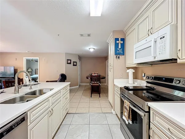 a kitchen that has a dining table and chairs