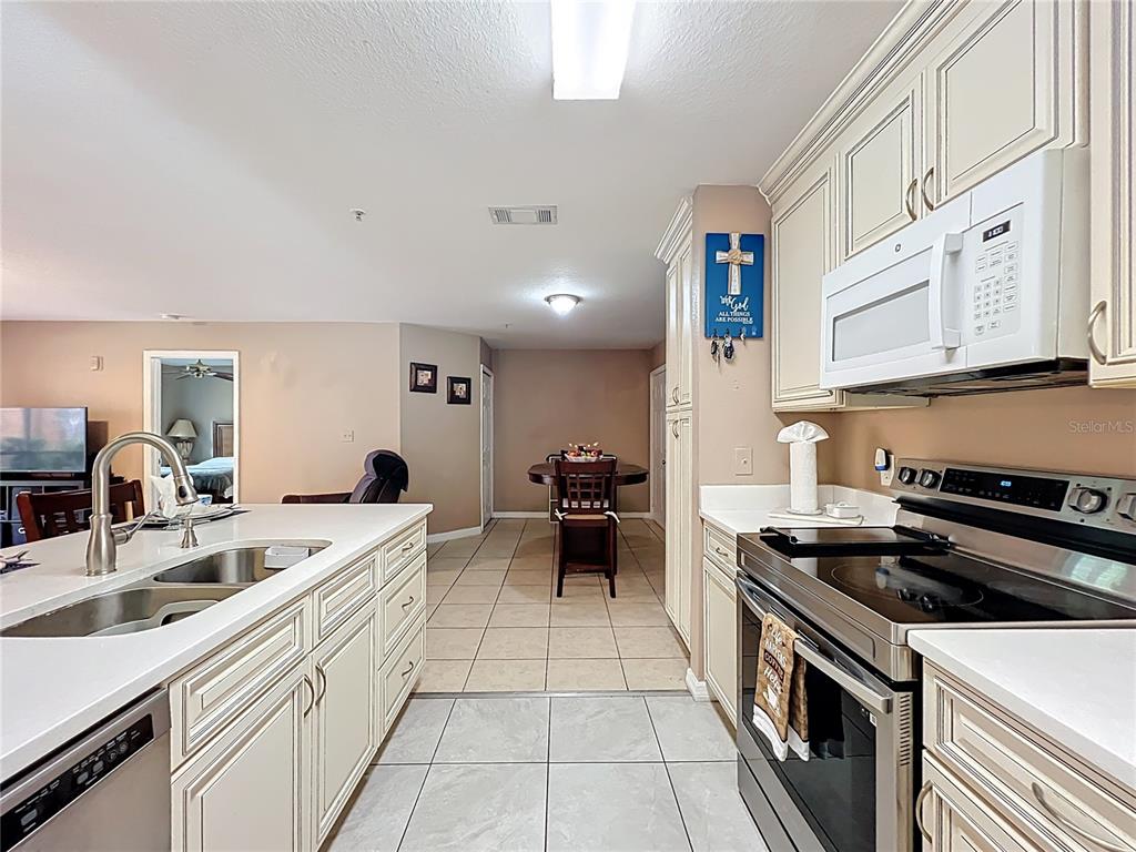 5471 Vineland Road, Unit 7109 Orlando, FL 32811 - Photo 14 of 60 a kitchen that has a sink and a stove