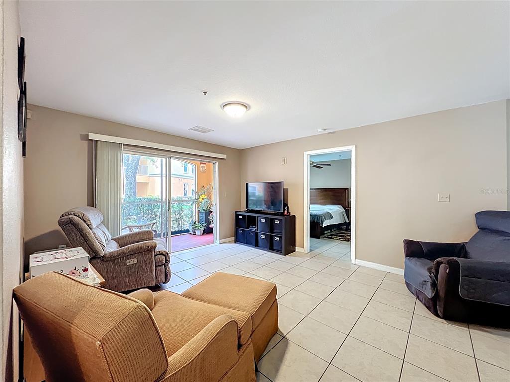 5471 Vineland Road, Unit 7109 Orlando, FL 32811 - Photo 22 of 60 a living room with furniture and a large window