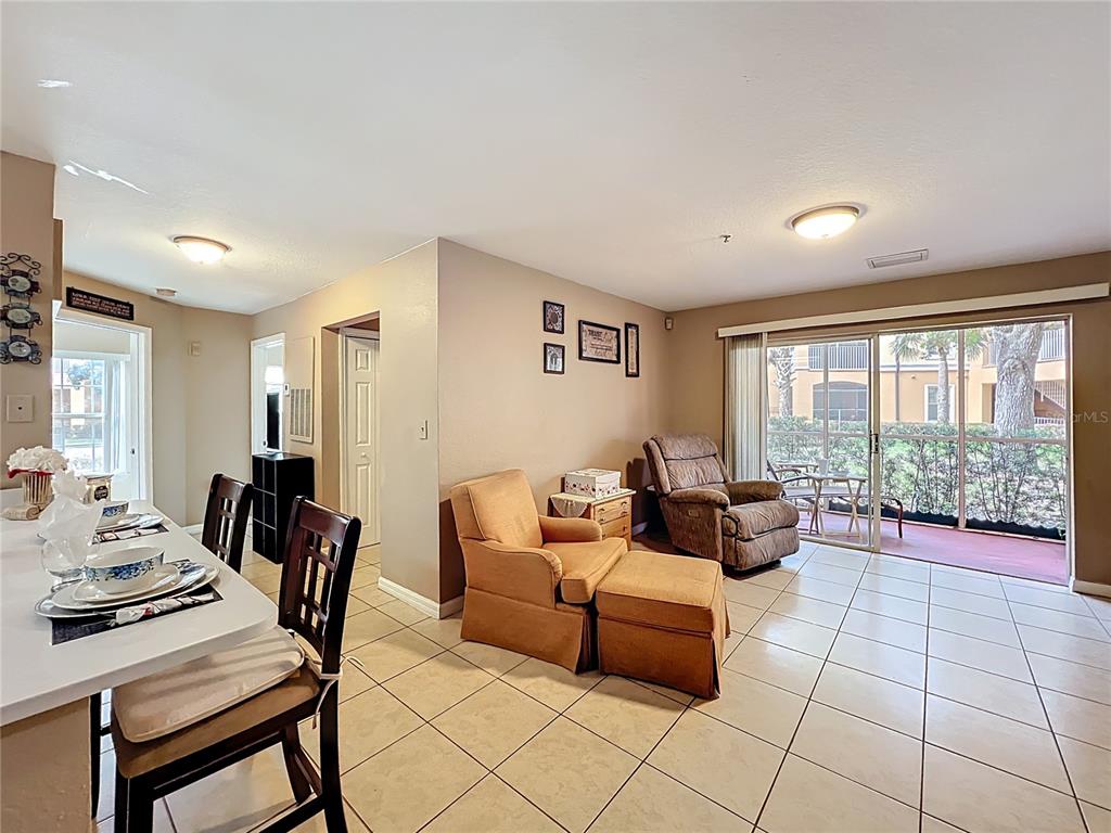 5471 Vineland Road, Unit 7109 Orlando, FL 32811 - Photo 23 of 60 a living room with furniture and large windows
