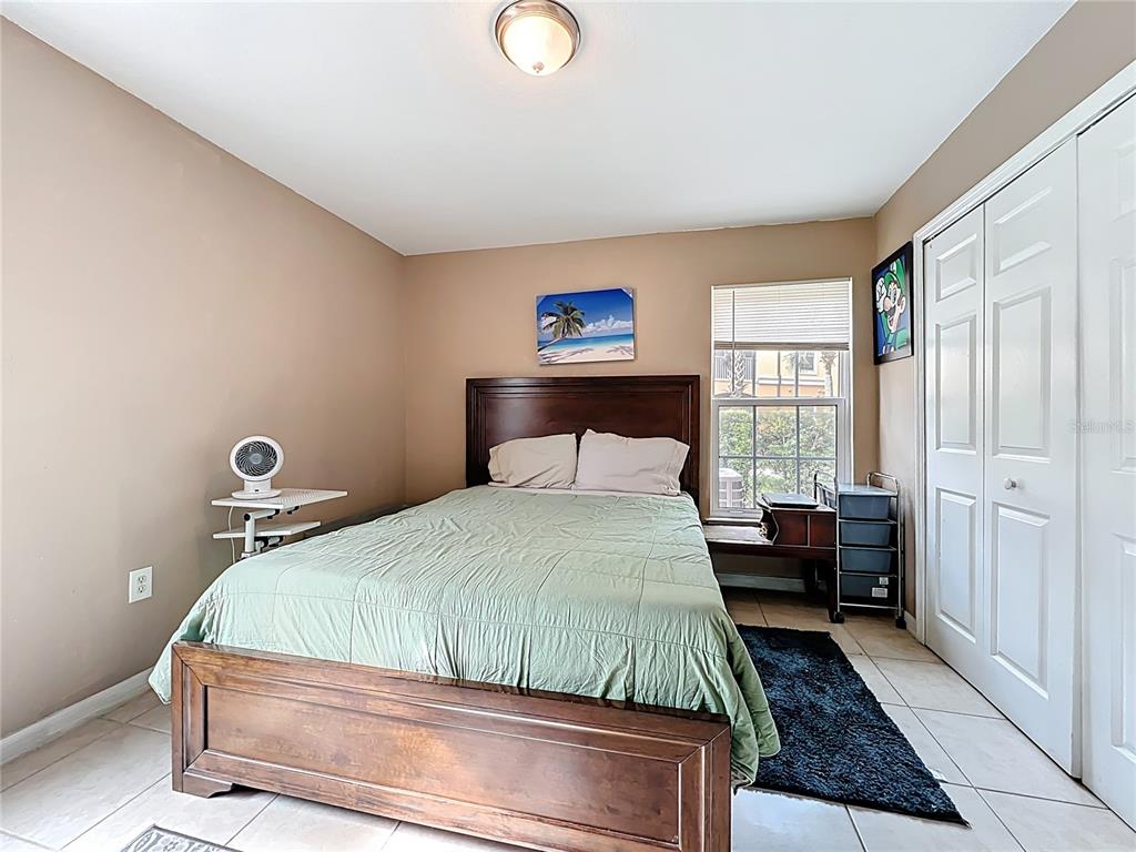 5471 Vineland Road, Unit 7109 Orlando, FL 32811 - Photo 28 of 60 a bedroom with a bed and window