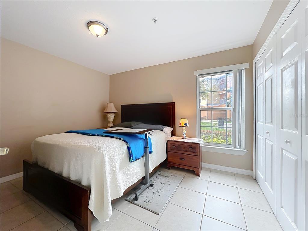 5471 Vineland Road, Unit 7109 Orlando, FL 32811 - Photo 29 of 60 a bed room with a bed and a television