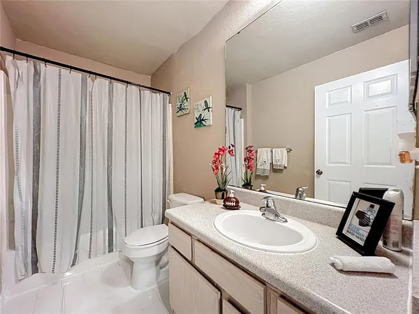 a bathroom with a sink mirror and toilet
