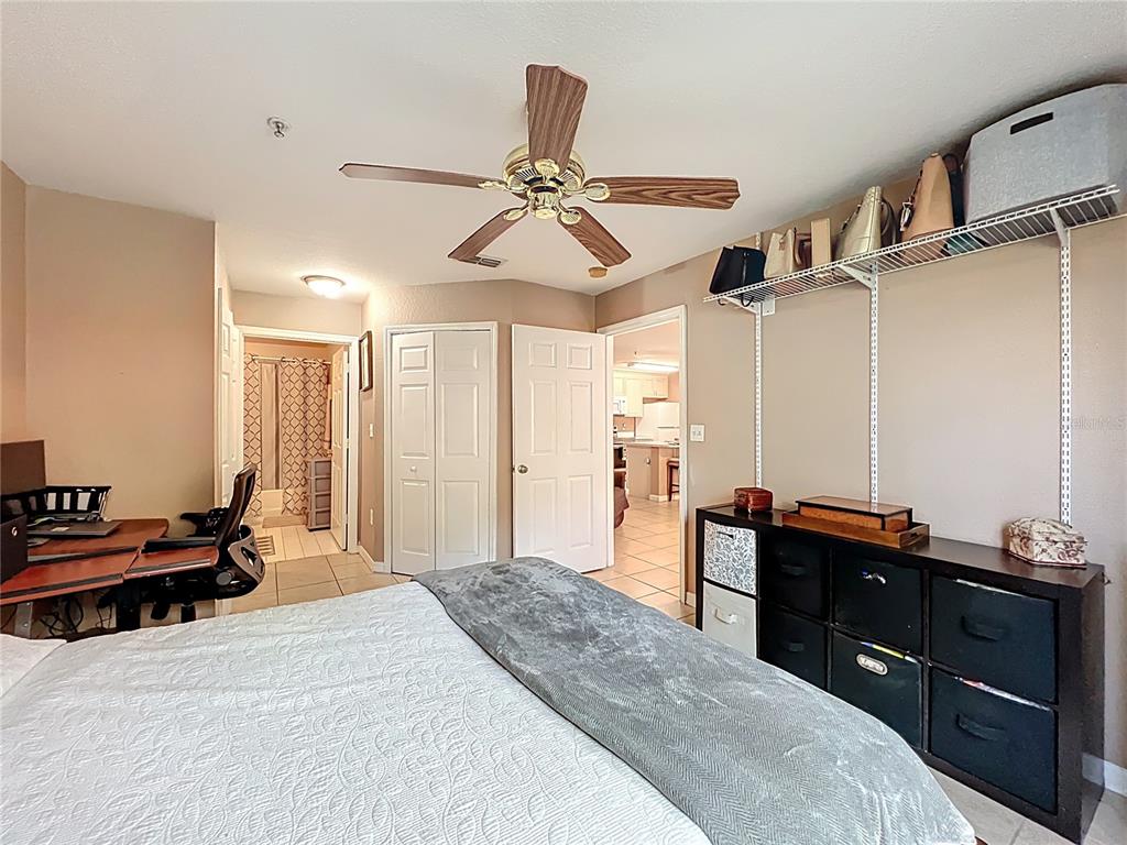 5471 Vineland Road, Unit 7109 Orlando, FL 32811 - Photo 32 of 60 a bedroom with a bed and a chandelier