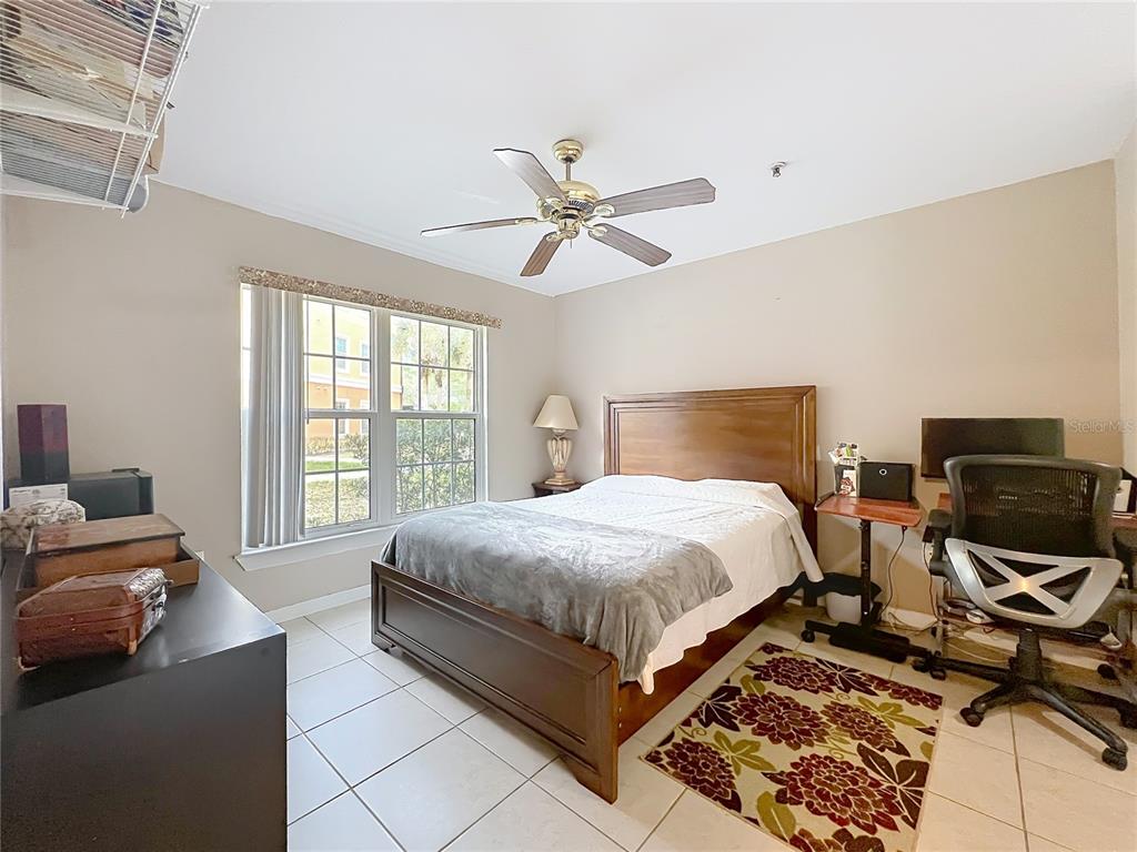 5471 Vineland Road, Unit 7109 Orlando, FL 32811 - Photo 33 of 60 a bedroom with a bed and wooden floor