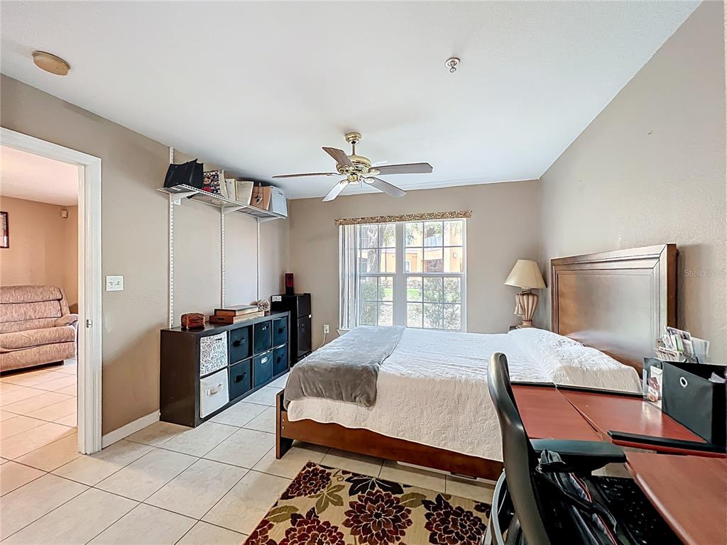 5471 Vineland Road, Unit 7109 Orlando, FL 32811 - Photo 34 of 60 a bed room with a bed and furniture