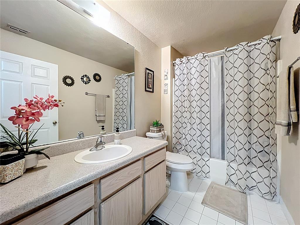 5471 Vineland Road, Unit 7109 Orlando, FL 32811 - Photo 35 of 60 a bathroom with a sink mirror and toilet