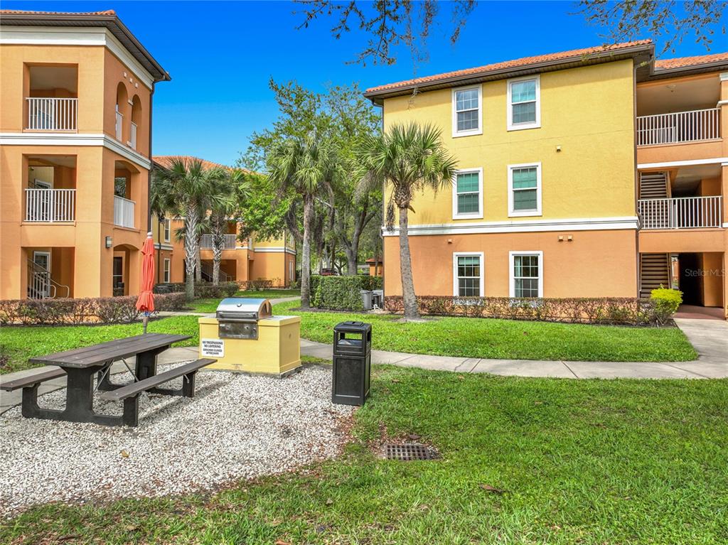 5471 Vineland Road, Unit 7109 Orlando, FL 32811 - Photo 43 of 60 a view of a house with a yard and sitting area