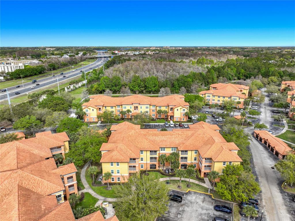 5471 Vineland Road, Unit 7109 Orlando, FL 32811 - Photo 44 of 60 an aerial view of residential houses with outdoor space and ocean view