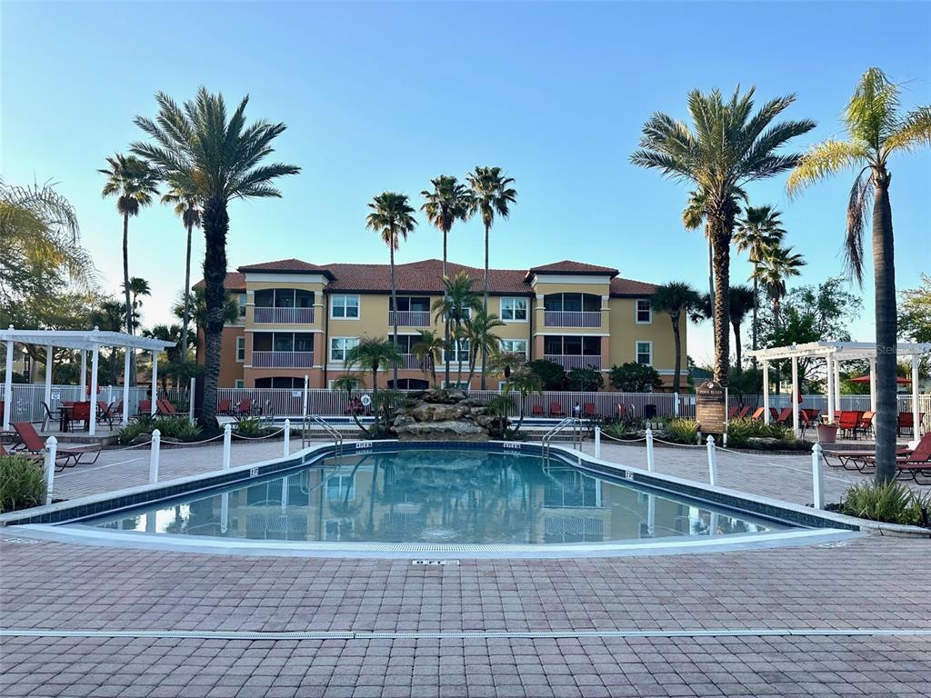 5471 Vineland Road, Unit 7109 Orlando, FL 32811 - Photo 51 of 60 a view of a swimming pool with palm trees