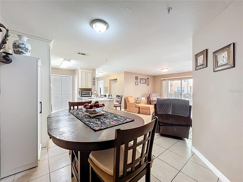 5471 Vineland Road, Unit 7109 Orlando, FL 32811 - Photo 7 of 60 a view of a dining room with furniture