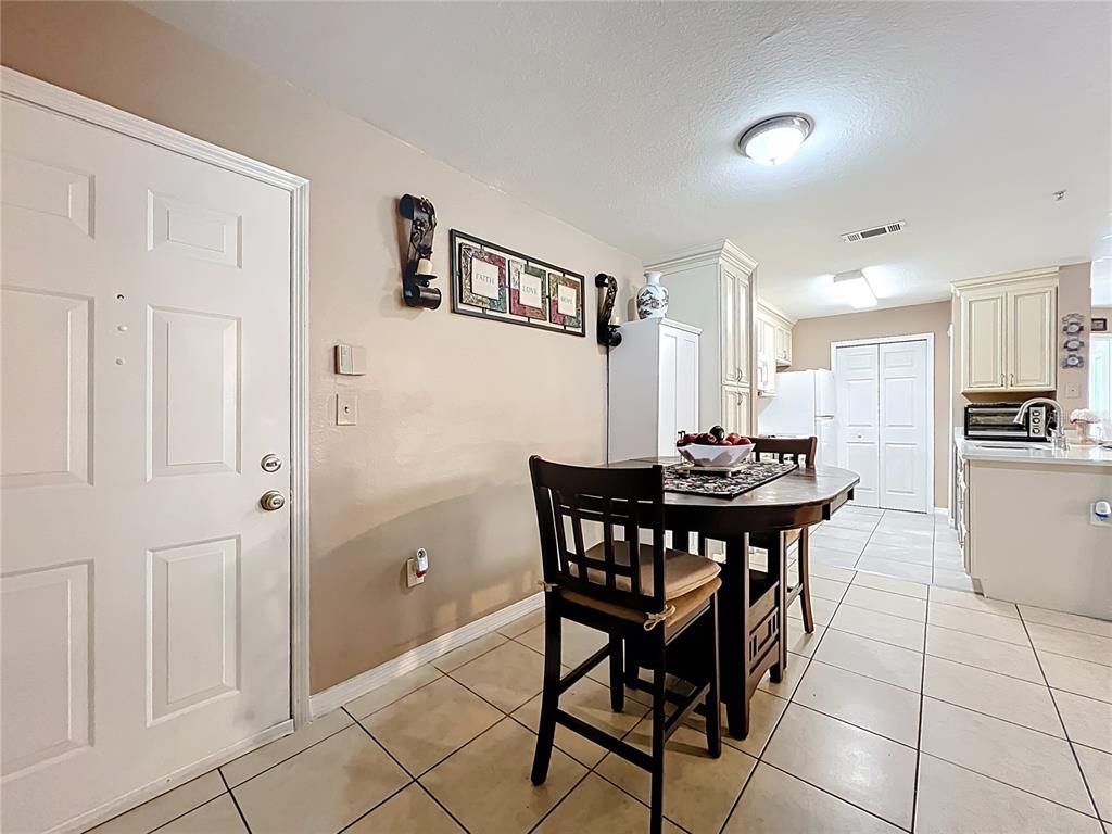 5471 Vineland Road, Unit 7109 Orlando, FL 32811 - Photo 8 of 60 a view of a dining room with furniture and a kitchen