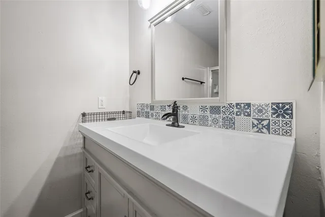 a bedroom with a bed and a chandelier fan