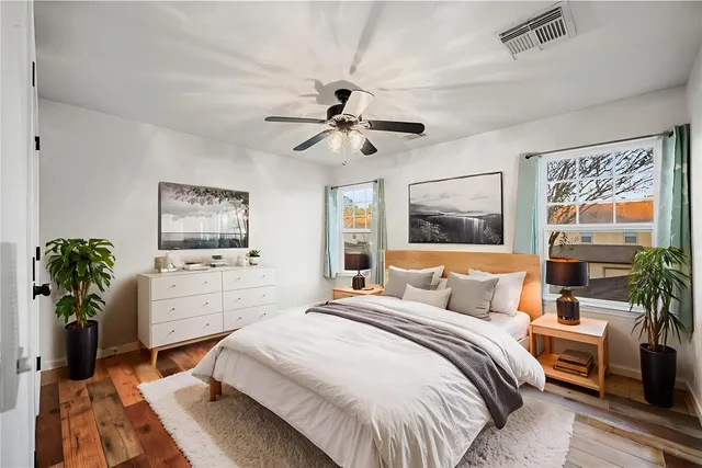 a kitchen with stainless steel appliances kitchen island a table chairs and a refrigerator