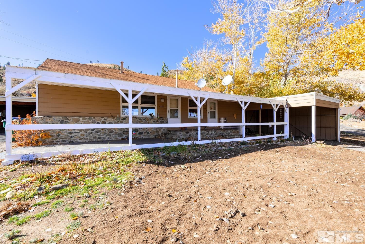 a view of a house with a backyard