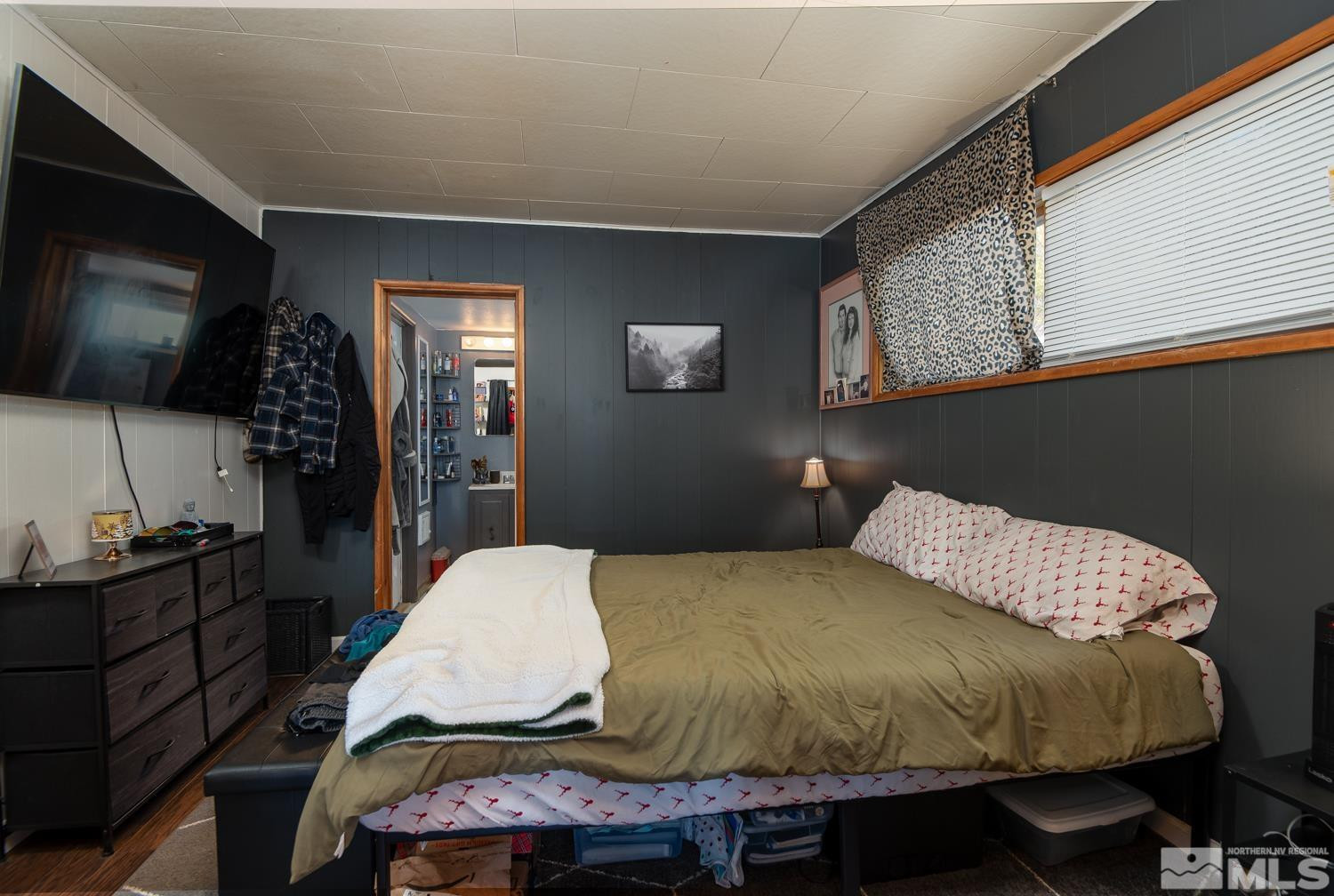 4240 Kings Canyon Road Carson City, NV 89703 - Photo 11 of 25 a bedroom with a bed and flat screen tv