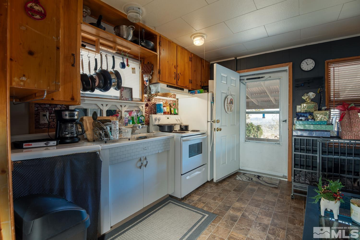 4240 Kings Canyon Road Carson City, NV 89703 - Photo 12 of 25 a kitchen with stainless steel appliances a refrigerator and a stove top oven