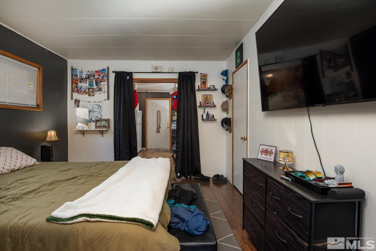 4240 Kings Canyon Road Carson City, NV 89703 - Photo 13 of 25 a bedroom with a bed and a flat screen tv